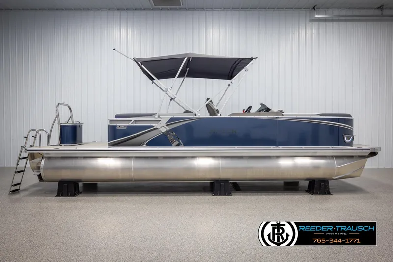 Slide: The Image of 2025 Avalon LSZ Entertainer pontoon boat with canopy in showroom, Reeder-Trausch Marine. - 5