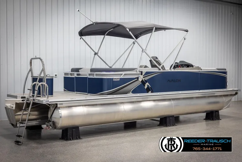 Slide: The Image of 2025 Avalon LSZ Entertainer pontoon boat with canopy, displayed indoors at Reeder-Trausch Marine. - 6