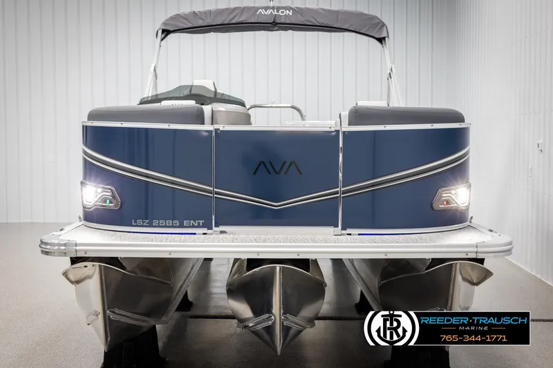 Slide: The Image of 2025 Avalon LSZ ENTERTAINER pontoon boat, blue exterior, displayed indoors at Reeder Trausch Marine. - 8