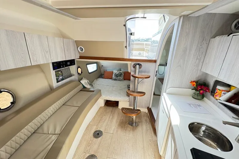 Slide: The Image of Luxurious 2024 Hanover 375 yacht interior with modern kitchen, cozy seating, and elegant wood accents. - 11