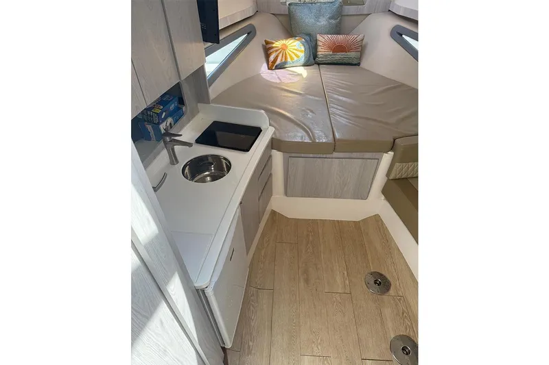 Slide: The Image of Compact interior of 2024 Hanover 375 boat with kitchenette and seating area. - 13