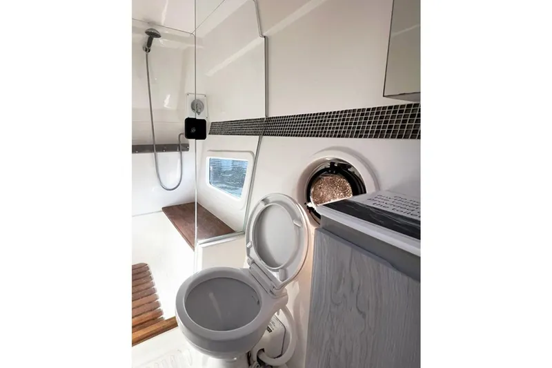 Slide: The Image of Modern bathroom in 2024 Hanover 375 RV with shower, toilet, and window. - 17