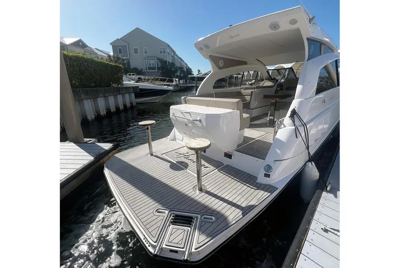 Slide: The Image of Luxury Hanover 375 yacht docked, showcasing sleek design and spacious deck, 2024 model. - 4