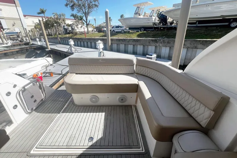 Slide: The Image of Luxurious seating on a 2024 Hanover 375 boat docked at a marina. - 5