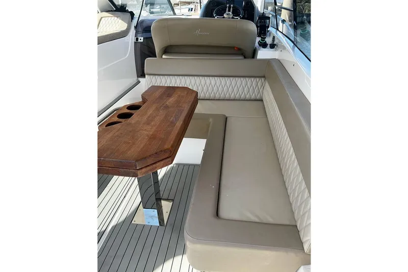 Slide: The Image of Luxurious interior of 2024 Hanover 375 boat with elegant seating and wooden table. - 7