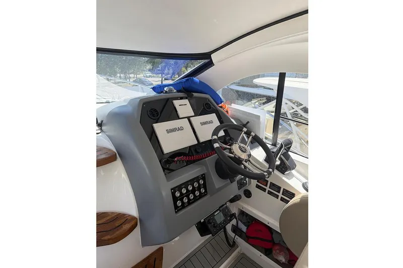 Slide: The Image of 2024 Hanover 375 boat cockpit with steering wheel and navigation equipment. - 9