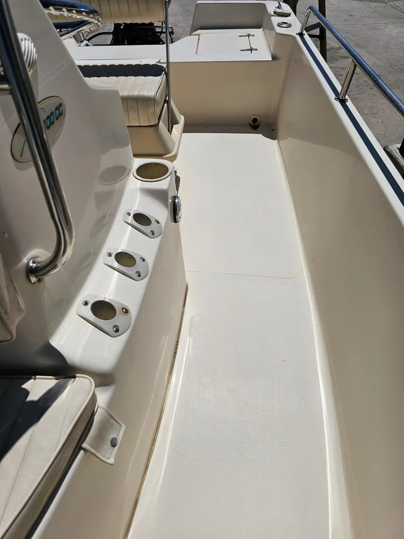 Slide: The Image of 2002 Sea Pro SV2100CC Bay Boat interior with rod holders and seating. - 25