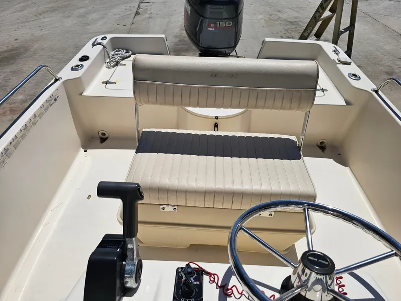 Slide: The Image of 2002 Sea Pro SV2100CC Bay Boat interior with steering wheel and seating. - 29