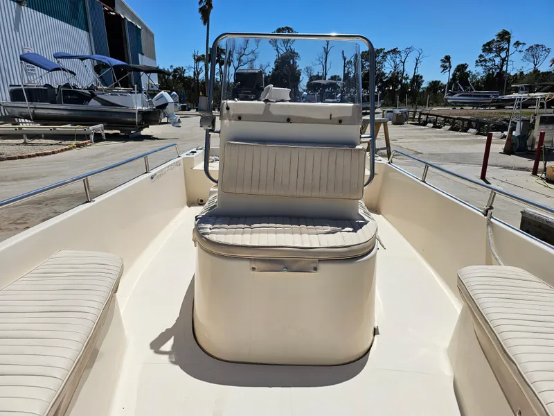 Slide: The Image of 2002 Sea Pro SV2100CC Bay Boat with seating, docked under clear blue sky. - 33