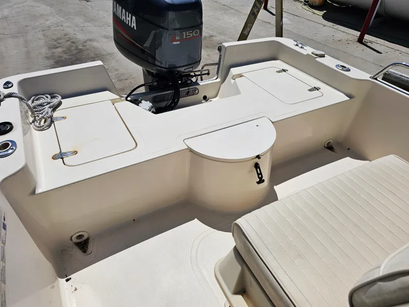 Slide: The Image of 2002 Sea Pro SV2100CC Bay Boat with Yamaha V6 150 engine, rear seating, and storage compartments. - 35