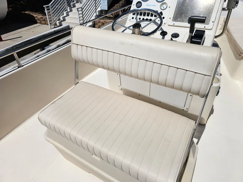 Slide: The Image of 2002 Sea Pro SV2100CC Bay Boat interior with steering console and cushioned seating. - 36