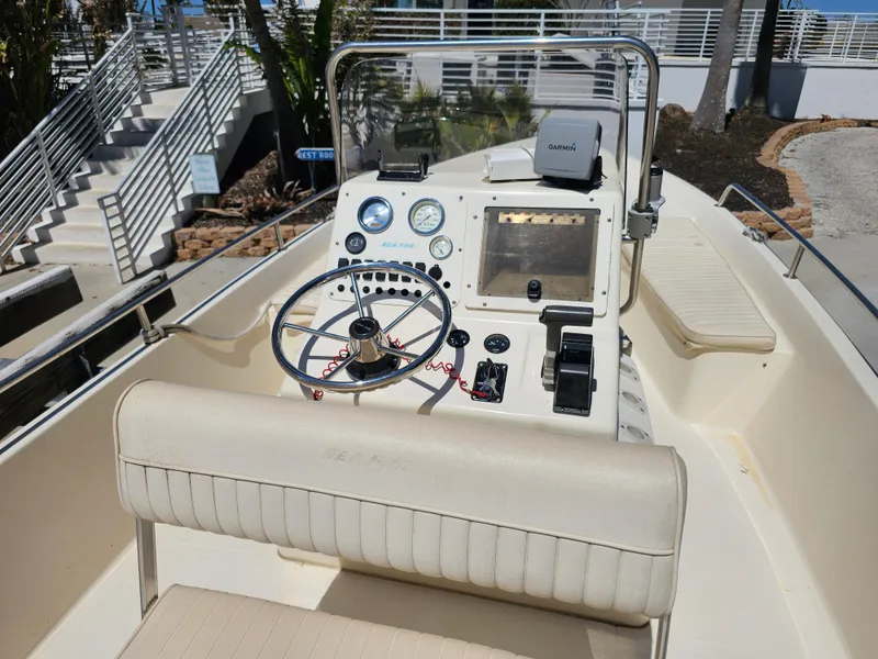 Slide: The Image of 2002 Sea Pro SV2100CC Bay Boat cockpit with steering wheel and navigation equipment. - 37