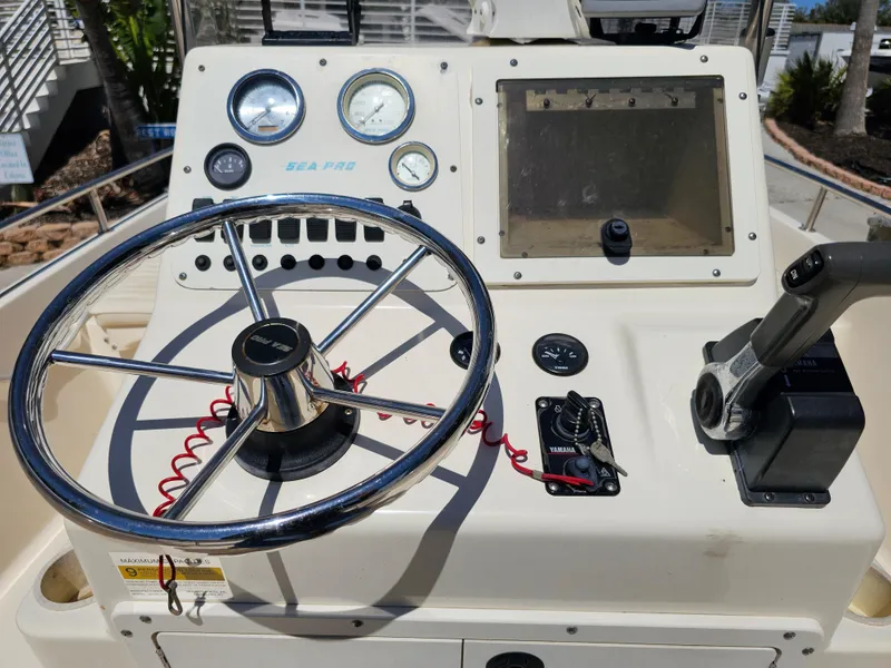 Slide: The Image of 2002 Sea Pro SV2100CC Bay Boat dashboard with steering wheel and controls. - 43