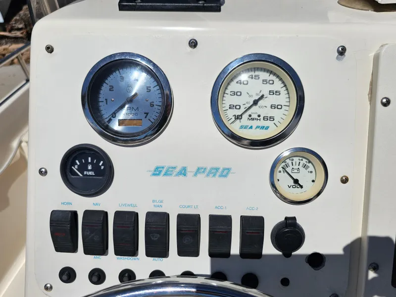 Slide: The Image of Dashboard of a 2002 Sea Pro SV2100CC Bay Boat with gauges and switches. - 46