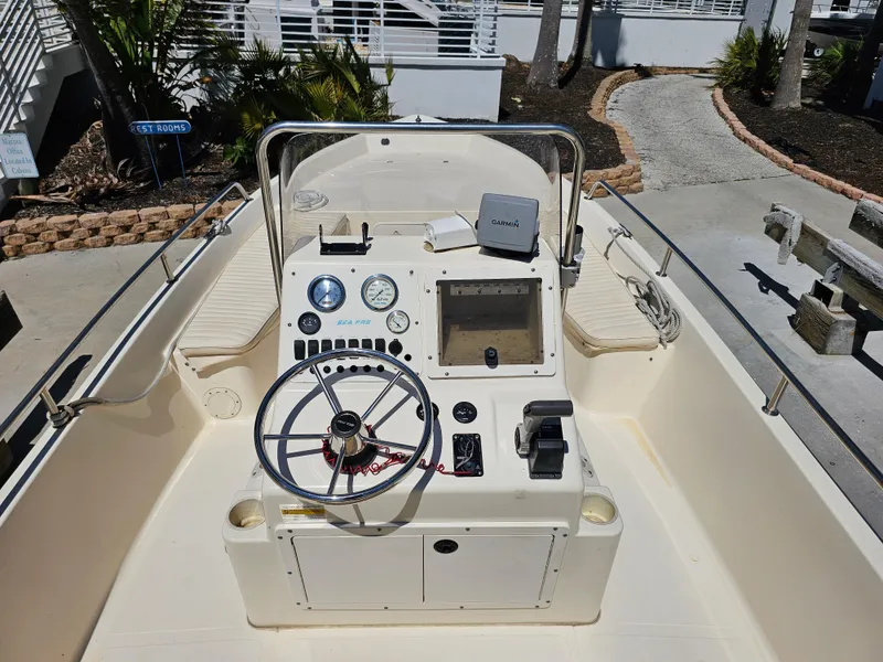 Slide: The Image of 2002 Sea Pro SV2100CC Bay Boat dashboard with steering wheel and navigation equipment. - 49