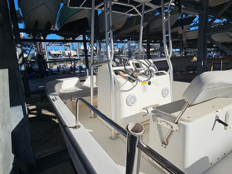 Slide: The Image of 2012 Boston Whaler 210 Montauk boat in storage, featuring console and seating. - 18