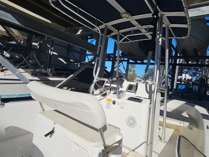 Slide: The Image of 2012 Boston Whaler 210 Montauk boat interior with steering console and seating. - 19