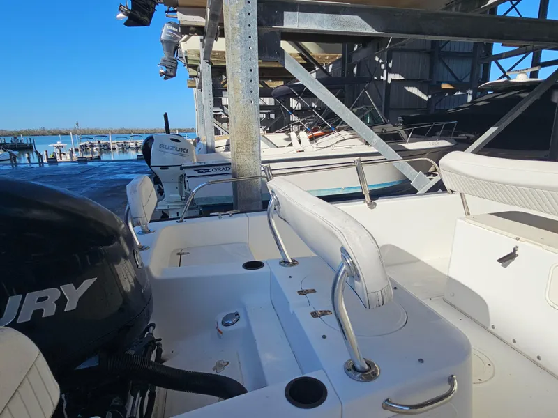 Slide: The Image of 2012 Boston Whaler 210 Montauk boat docked, featuring Mercury and Suzuki engines. - 21