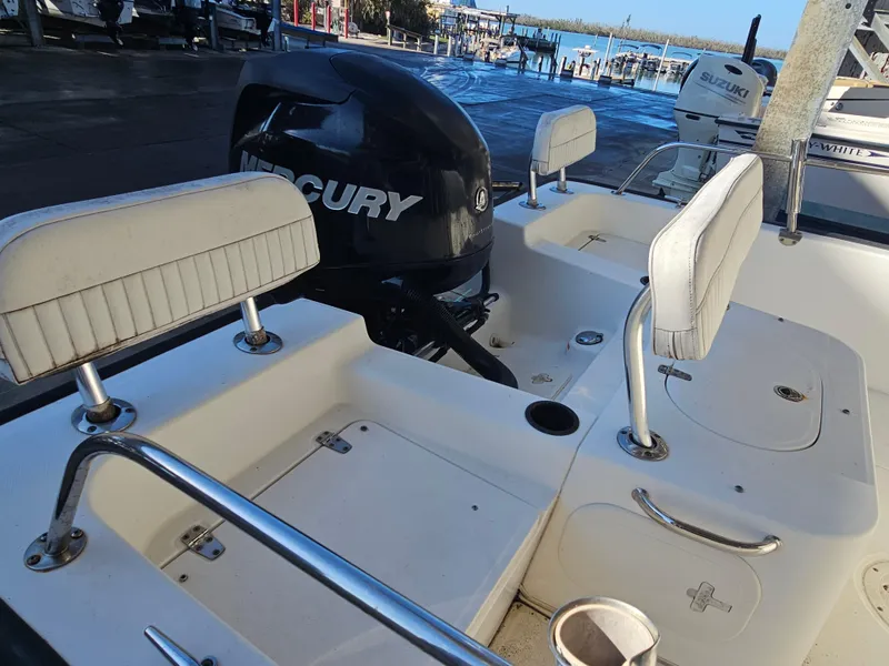 Slide: The Image of 2012 Boston Whaler 210 Montauk boat interior with Mercury engine and seating. - 22