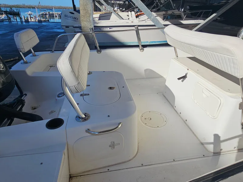 Slide: The Image of 2012 Boston Whaler 210 Montauk boat interior with seating and storage compartments. - 23