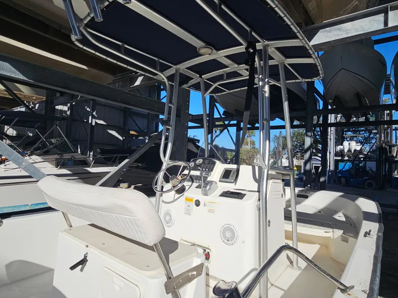 Slide: The Image of 2012 Boston Whaler 210 Montauk boat interior with steering console and seating. - 25