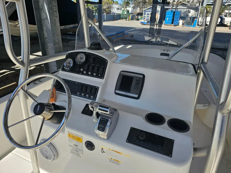 Slide: The Image of Boston Whaler 210 Montauk 2012 boat console with steering wheel and controls. - 27