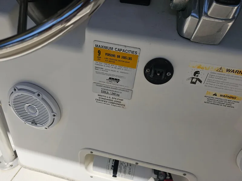 Slide: The Image of Boston Whaler 210 Montauk 2012 boat dashboard with capacity and safety warnings. - 31