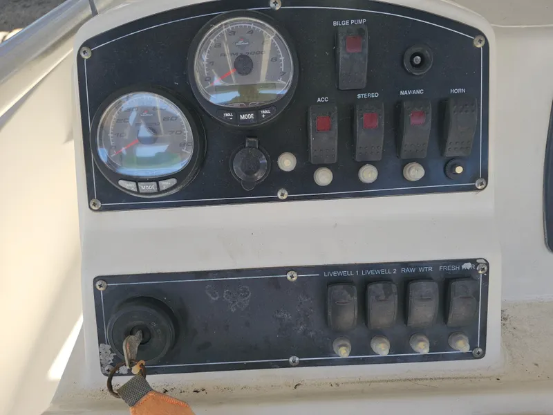 Slide: The Image of Control panel of a 2012 Boston Whaler 210 Montauk boat with gauges and switches. - 38