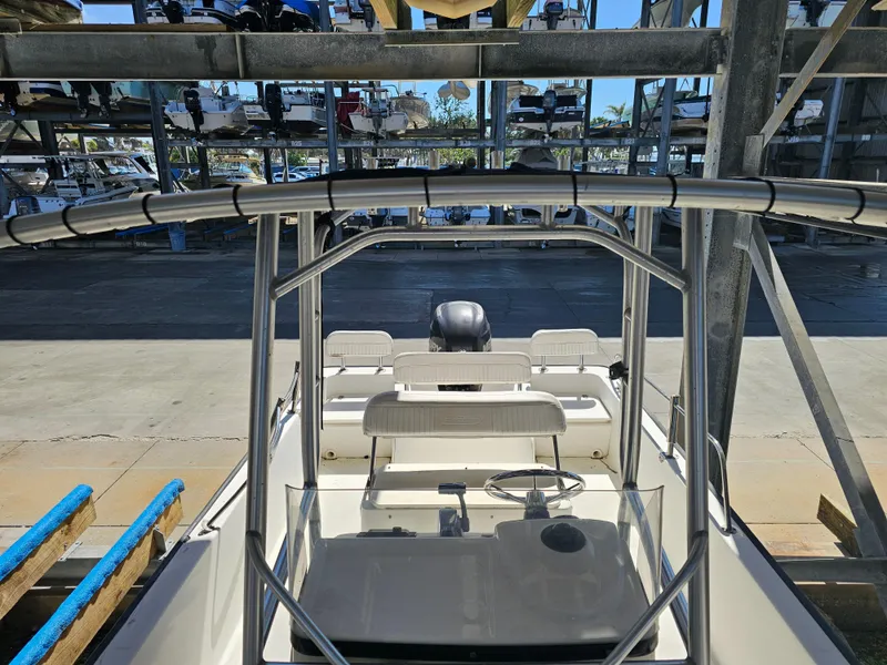 Slide: The Image of Boston Whaler 210 Montauk 2012 boat in storage, viewed from above, showcasing helm and seating. - 44