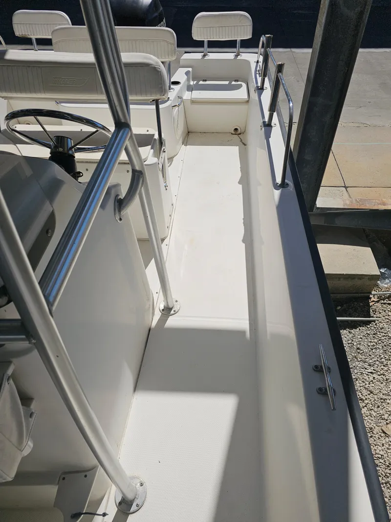 Slide: The Image of 2012 Boston Whaler 210 Montauk boat interior with seating and steering wheel. - 46
