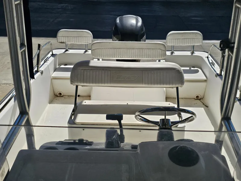 Slide: The Image of 2012 Boston Whaler 210 Montauk boat interior with steering wheel and seating. - 47