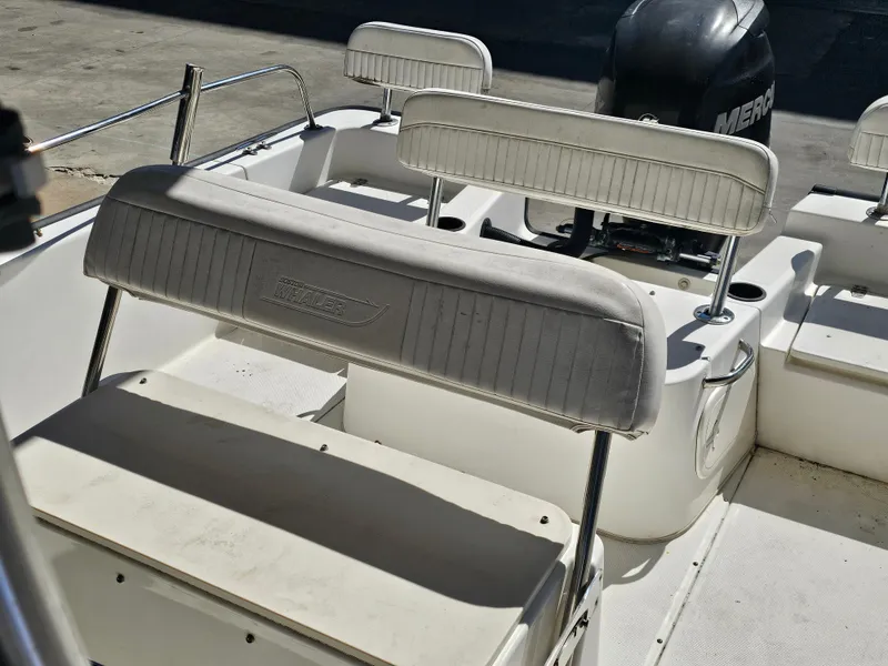 Slide: The Image of 2012 Boston Whaler 210 Montauk boat interior with seating and Mercury engine. - 48