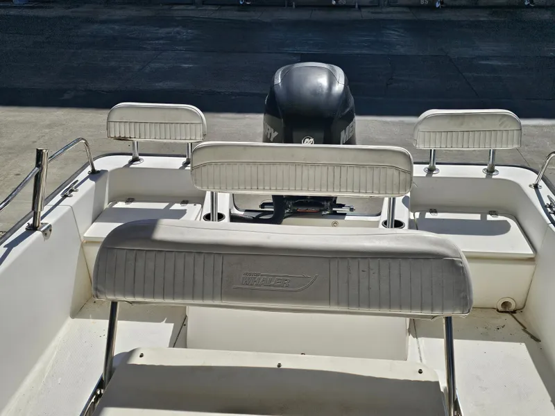 Slide: The Image of 2012 Boston Whaler 210 Montauk boat interior with seating and engine view. - 49