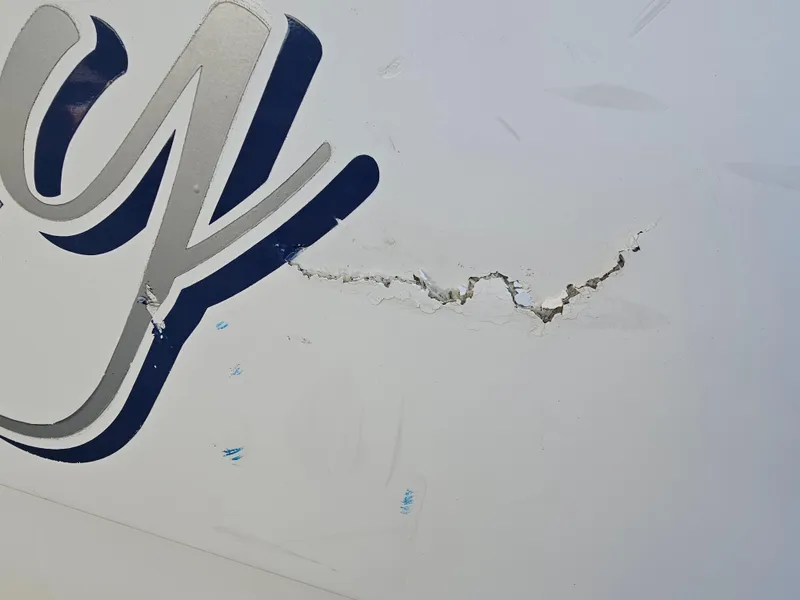Slide: The Image of Cracked hull on 2012 Boston Whaler 210 Montauk boat with visible damage. - 5