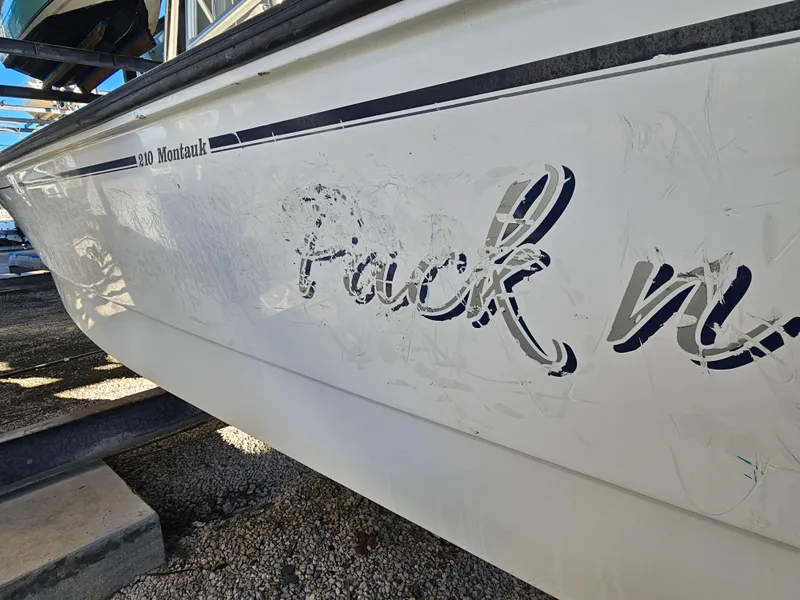 Slide: The Image of 2012 Boston Whaler 210 Montauk boat with faded lettering on the side. - 6