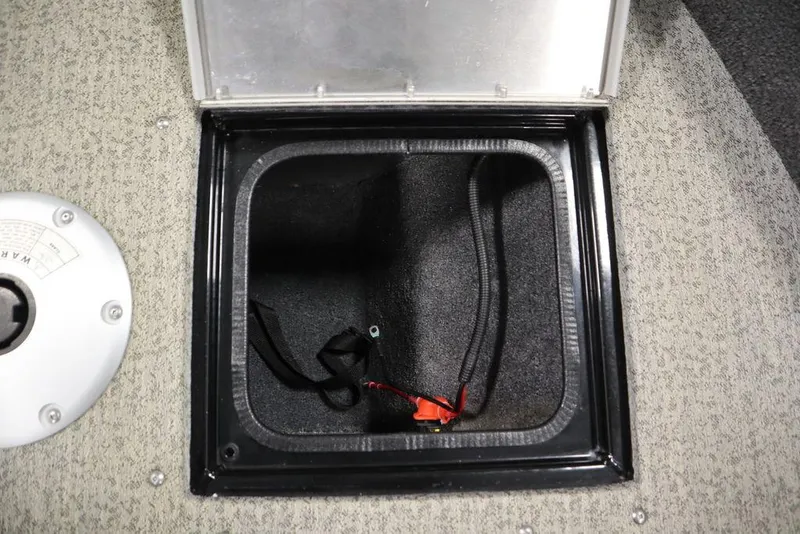 Slide: The Image of 2023 Tracker V16 Pro Guide WT storage compartment with open lid and visible wiring. - 18