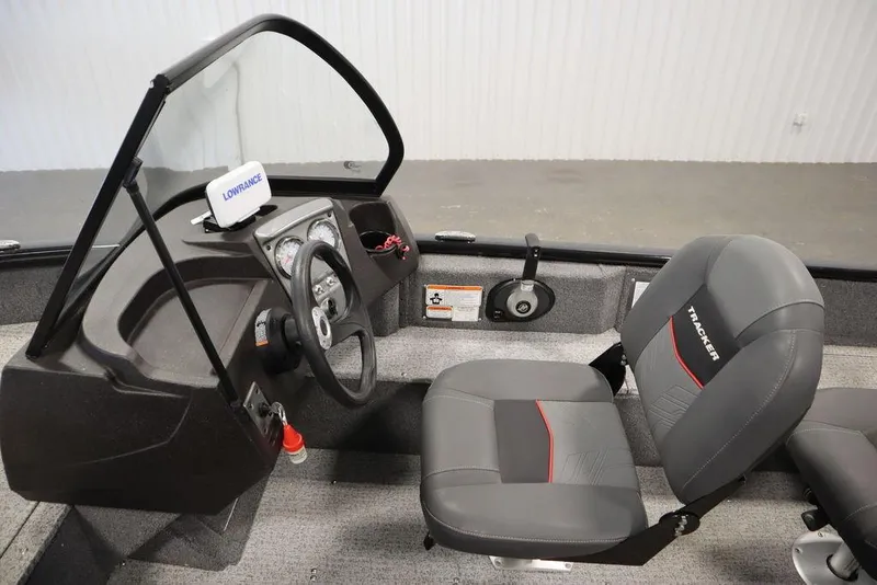 Slide: The Image of 2023 Tracker V16 Pro Guide WT boat interior with steering console and seating. - 21