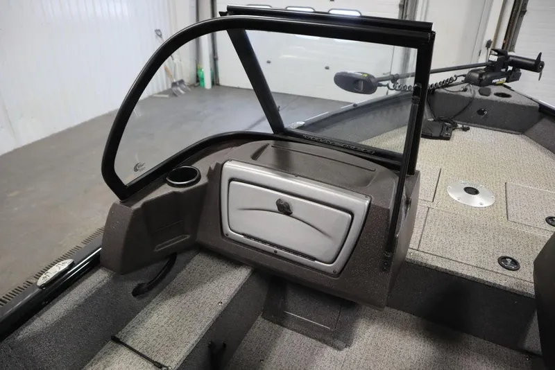Slide: The Image of 2023 Tracker V16 Pro Guide WT boat interior with windshield and storage compartment. - 30