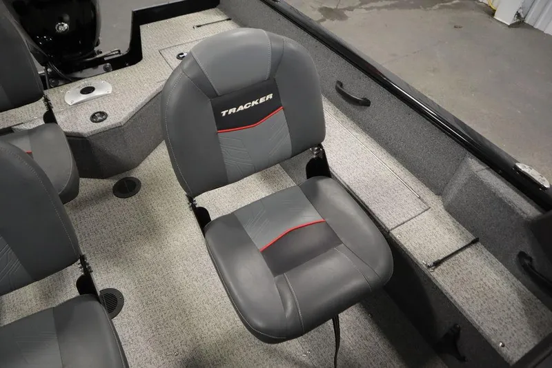 Slide: The Image of 2023 Tracker V16 Pro Guide WT boat interior with gray seating and carpeted flooring. - 34