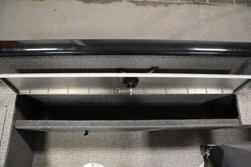 Slide: The Image of 2023 Tracker V16 Pro Guide WT boat storage compartment, open and empty, with gray interior. - 36
