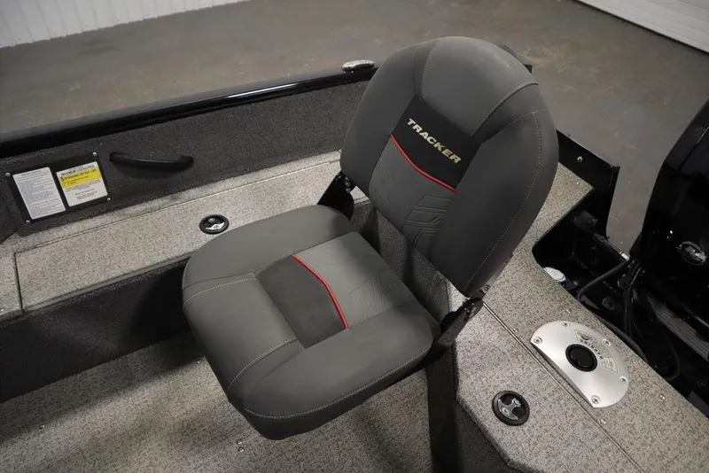 Slide: The Image of 2023 Tracker V16 Pro Guide WT boat seat with gray upholstery and red accents. - 38