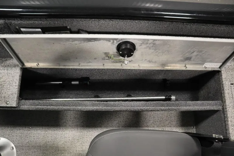 Slide: The Image of 2023 Tracker V16 Pro Guide WT storage compartment with rod holder, open lid view. - 40