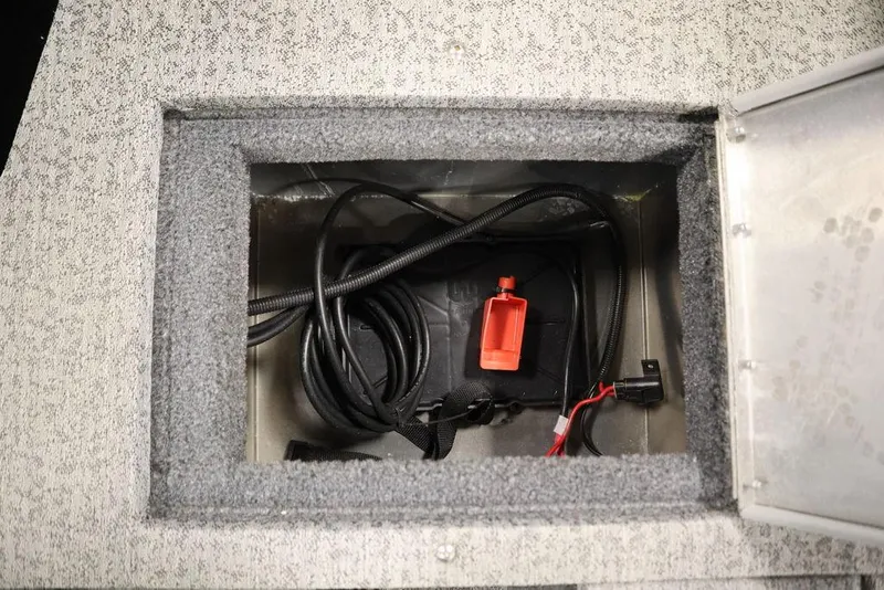 Slide: The Image of 2023 Tracker V16 Pro Guide WT storage compartment with wiring and red connector. - 42
