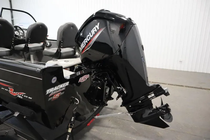 Slide: The Image of 2023 Tracker V16 Pro Guide WT boat with Mercury outboard motor in a showroom. - 47