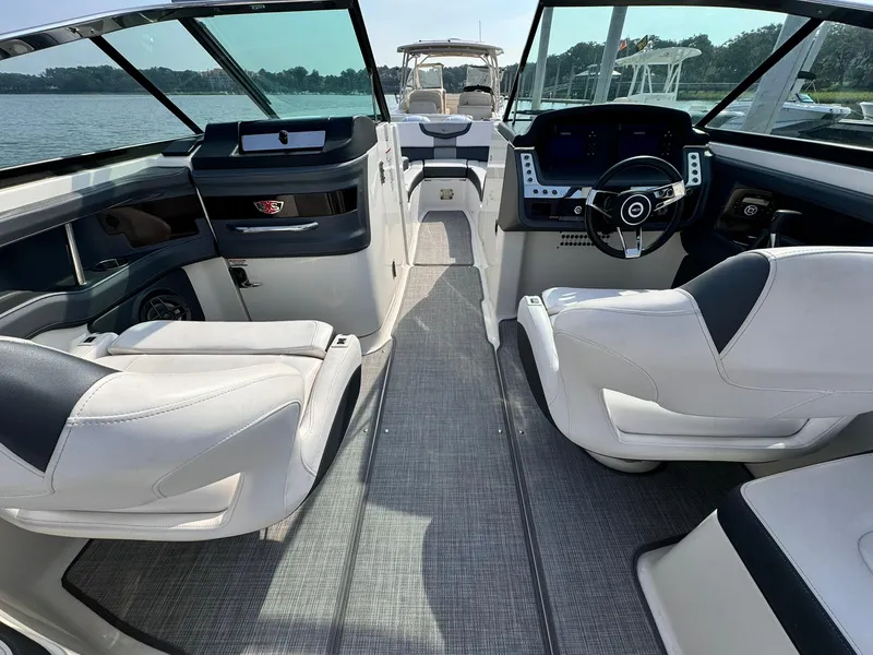 Slide: The Image of 2021 Chaparral 307 SSX boat interior with modern dashboard and comfortable seating. - 15