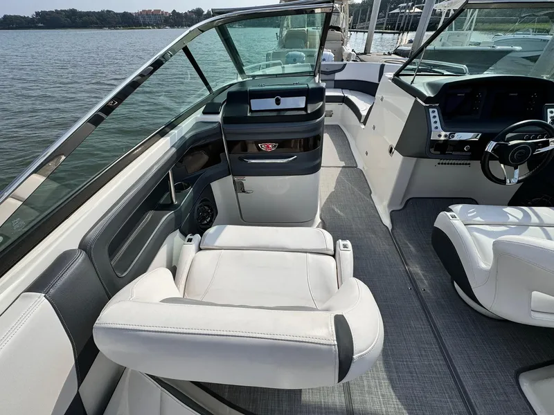 Slide: The Image of 2021 Chaparral 307 SSX boat interior with luxurious seating and modern dashboard. - 16