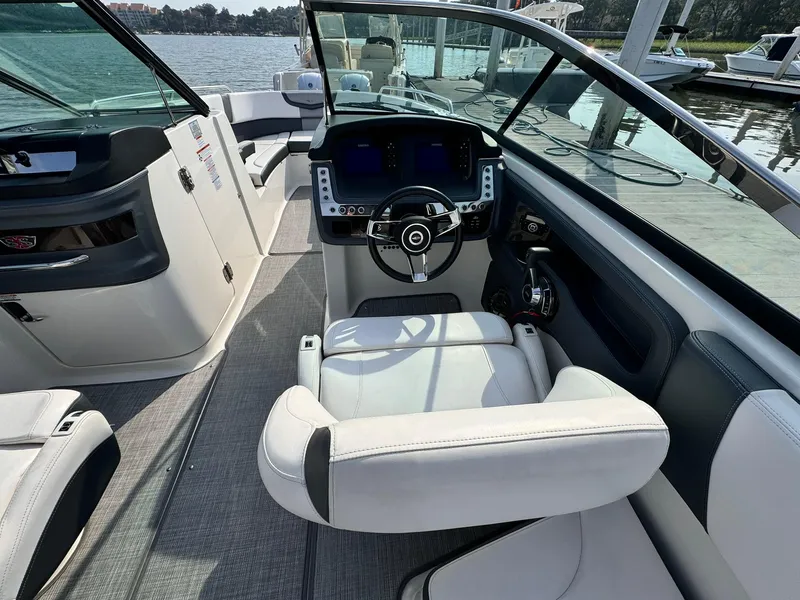 Slide: The Image of 2021 Chaparral 307 SSX boat interior with modern dashboard and steering wheel. - 17