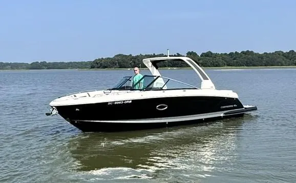 Slide: The Image of 2021 Chaparral 307 SSX boat cruising on a calm lake. - 2