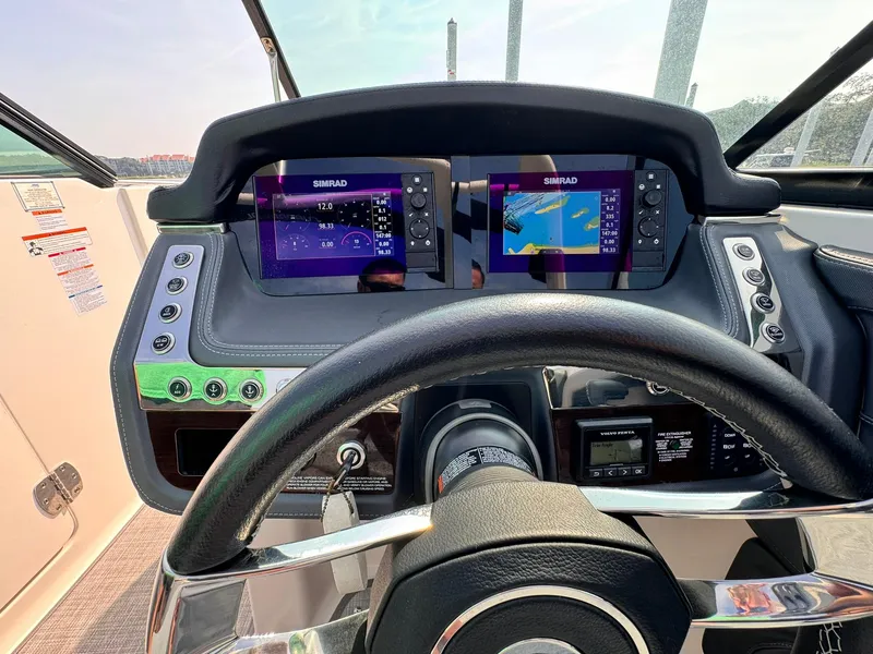Slide: The Image of 2021 Chaparral 307 SSX dashboard with dual Simrad displays and steering wheel. - 20