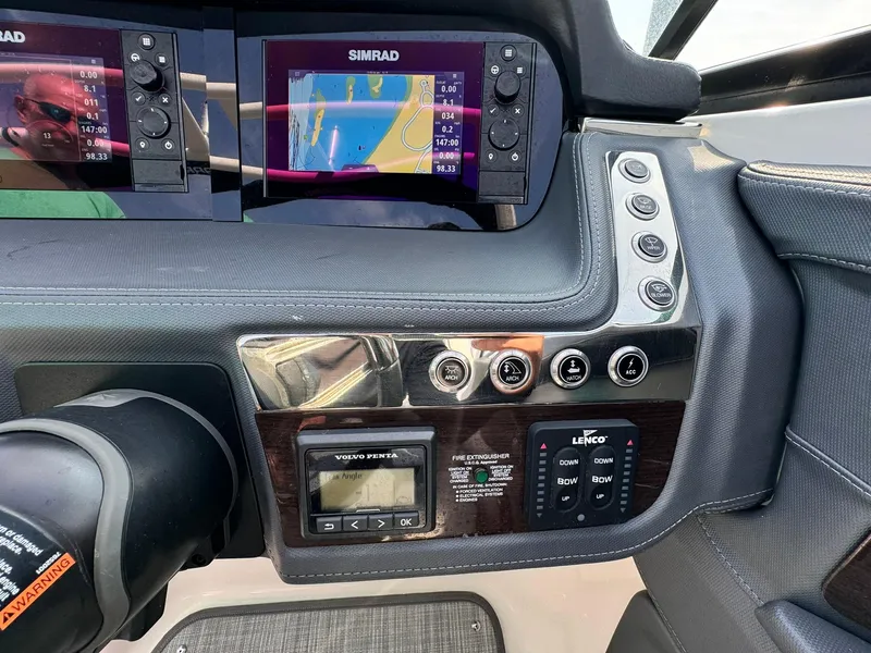 Slide: The Image of Dashboard of 2021 Chaparral 307 SSX with Simrad navigation displays and control panels. - 21